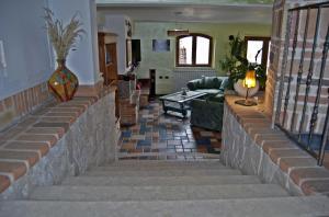ein Wohnzimmer mit einer Treppe mit einer Vase in der Unterkunft Casa Hotel Civitella in Civitella Alfedena