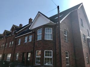 a red brick building with a white roof at 4 bed Duplex Apartment, Belfast in Belfast