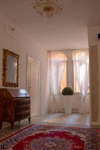 a living room with a piano and a window at Porta Orientalis Venice in Venice