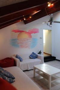 una sala de estar con sofá y una pintura en la pared en Casa Helios, en Albenga