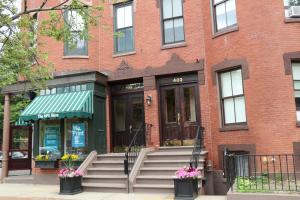 a brick building with a entrance to a store at Charming Studio in Boston Brownstone, C.Ave#5 in Boston +5 photos