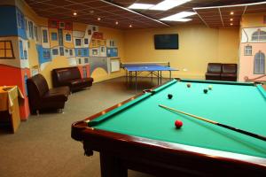 a billiard room with a pool table and chairs at Topaz Hotel in Kamensk-Uralsky