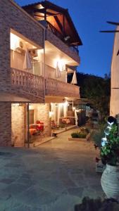 a large house with a balcony at night at Studios Lia Adults Only -Fully Renovated in Chrysi Ammoudia