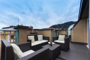 a balcony with wicker furniture on a roof at Attic+views+terrace+parking in Donostia-San Sebastián