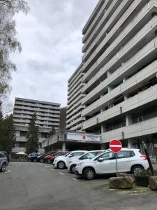 a parking lot with cars parked in front of a building at Mariposa inclusive Pool und Sauna in Bad Harzburg