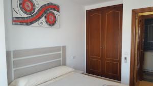 Posteľ alebo postele v izbe v ubytovaní Apartamento Arosa Playa