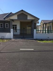 a house with a driveway in front of it at Zara Homestay in Marang