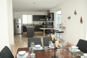 a kitchen and dining room with a table and chairs at Perfect Location & Security @ El Deseo Residencial in Buenavista