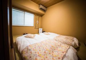 a bedroom with two beds and a window at Kyoto - House / Vacation STAY 3816 in Kyoto