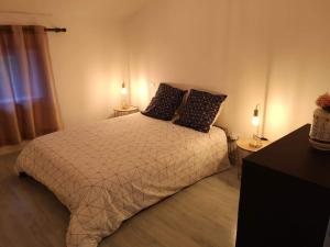 a bedroom with a bed with two pillows on it at La Roseraie à 10min du Puy du fou in Saint-Mars-la-Réorthe