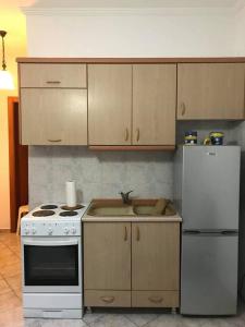 a kitchen with a white stove and a refrigerator at Harmony Apartment in Kallithea Halkidikis