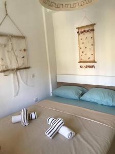 a bedroom with a bed and two socks on the floor at Harmony Apartment in Kallithea Halkidikis