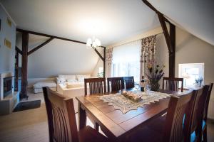 a dining room with a wooden table and chairs at Dom "Przy Kuźni" in Krotoszyny