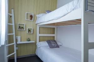 1 Schlafzimmer mit 2 Etagenbetten und einer Leiter in der Unterkunft tuGuest Violeta's Home in Granada