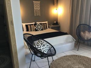 阿彻奇洛斯Fiore di Flora的一间卧室，里面有一张床和两把椅子