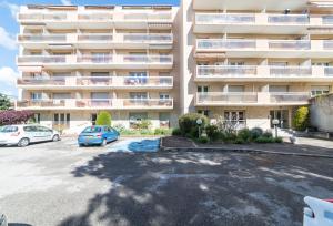 a parking lot in front of a large apartment building at A 2 pas du Palais free parking in Avignon