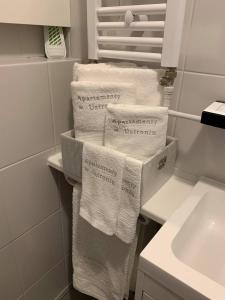a pile of towels on a shelf in a bathroom at Apartamenty w Ustroniu in Ustroń +55 photos