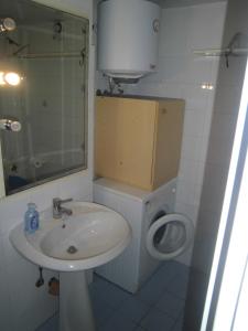 a white bathroom with a sink and a toilet at due passi dal mare in San Benedetto del Tronto