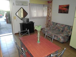 a living room with a table with a vase of flowers on it at due passi dal mare in San Benedetto del Tronto