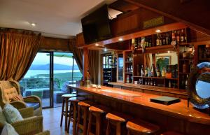 a bar in a restaurant with a view at Stirling Manor Boutique Guest House in Hartbeespoort