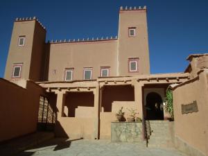 a building with a clock tower on top of it at Hotel Tomboctou in Tinerhir