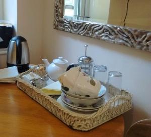 a wicker tray with a tea set on a table at Sunny Patch in Stroud