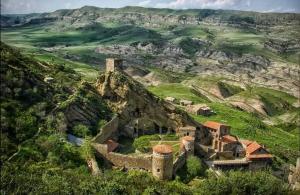 an old castle on a hill with mountains in the background at Home in Udabno in Udabno +40 photos