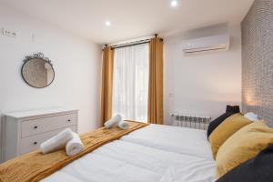 Katil atau katil-katil dalam bilik di Apartamentos Reina Isabel