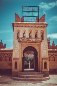 a building with a sign on top of it at Kasbah Ait Kassi in Boumalne