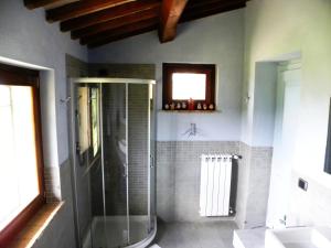 a bathroom with a shower with a glass door at Appartamenti Verde Collina Umbra in Bevagna