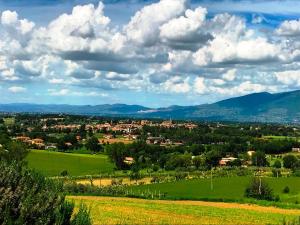 a view of a town in a green field at Appartamenti Verde Collina Umbra in Bevagna