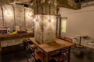 a kitchen with a table and chairs in a room at Midnight Rockers in Kanazawa