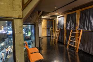 an empty room with a chair and a window at Midnight Rockers in Kanazawa