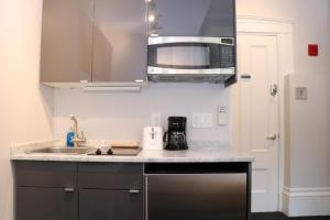 a kitchen with a sink and a microwave at Charming & Stylish Studio on Beacon Hill #6 in Boston
