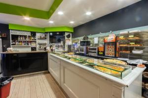 a bakery with a counter with a lot of food at Bed & Breakfast Il Castellino in Santo Stefano di Camastra +25 photos