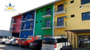 a row of cars parked in front of a building at Pousada Cores in Navegantes