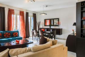 a living room with a couch and a dining room at Calliope Corfu Apartments in Corfu