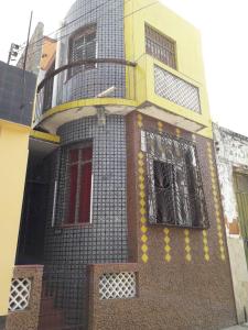 a building with a balcony on the side of it at Kitnet Mobiliada in São Luís