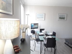 a dining room with a blue table and chairs at Apartment with Car Park - Bastille Neighborhood in Paris