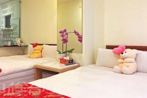Postel nebo postele na pokoji v ubytování Sun Moon Lake Crown Yu Hotel