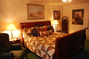 a bedroom with a bed and a chair at Novel House Inn at Zion in Springdale