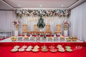 a table with cupcakes and plates of food on it at S-Tawan Hotel & Convention in Maha Sarakham