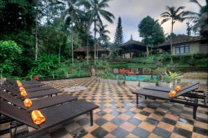 a row of benches with lights on them on a patio at Cempaka Belimbing Villa in Blimbing