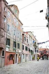 an empty street in an old town with buildings at Biennale 1215 in Venice