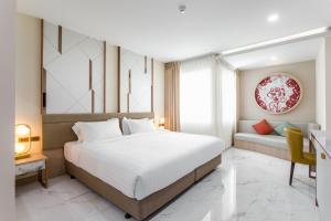 Postel nebo postele na pokoji v ubytování The 8 Hotel Udonthani