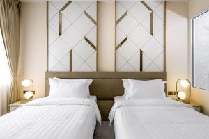 Postel nebo postele na pokoji v ubytování The 8 Hotel Udonthani