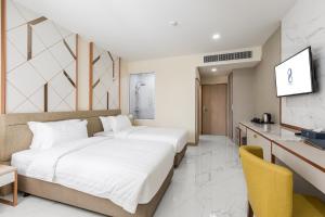 Postel nebo postele na pokoji v ubytování The 8 Hotel Udonthani