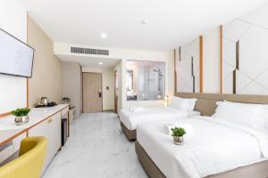 Postel nebo postele na pokoji v ubytování The 8 Hotel Udonthani