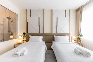 Postel nebo postele na pokoji v ubytování The 8 Hotel Udonthani