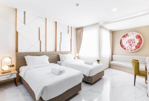 Postel nebo postele na pokoji v ubytování The 8 Hotel Udonthani